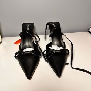 Never worn black kitten heels. Strap wraps around the ankle.